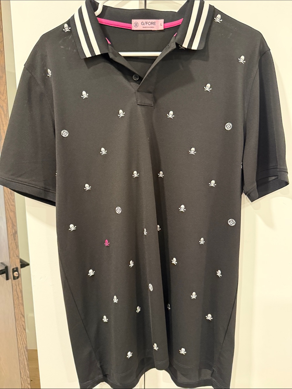 G/FORE Black Polo with White Skull Embroidery and Pink Trim